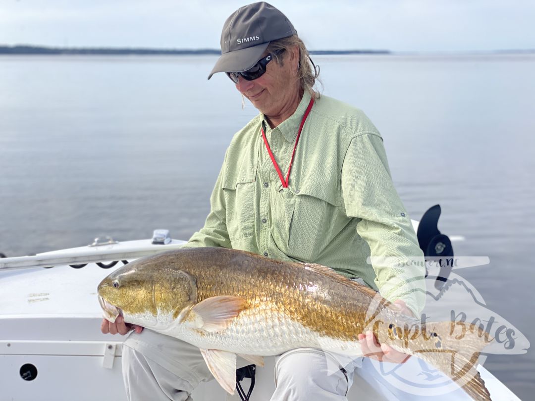 Mr Jim admiring the first of many trophy redfish he caught in two days fishing with me.